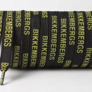 Шнурок плоский чорний з написом BIKKEMBERGS зеленим, ширина 10мм.  довжина 120см.